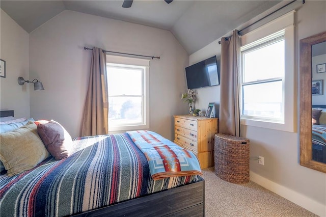 bedroom with multiple windows, lofted ceiling, and carpet