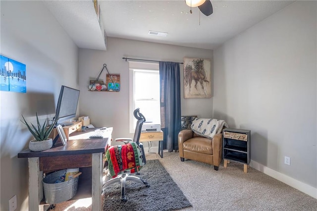 office space featuring carpet flooring, a ceiling fan, and baseboards