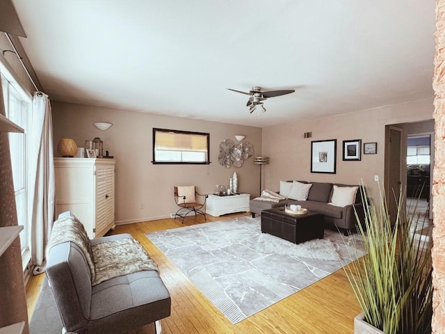 living room with ceiling fan and light wood-style flooring