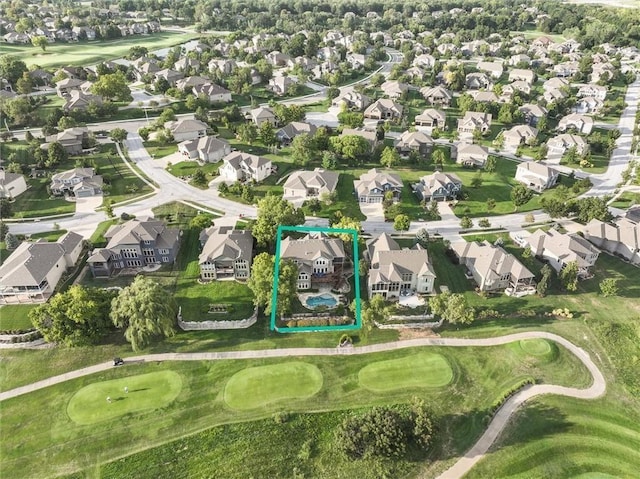 birds eye view of property with view of golf course and a residential view