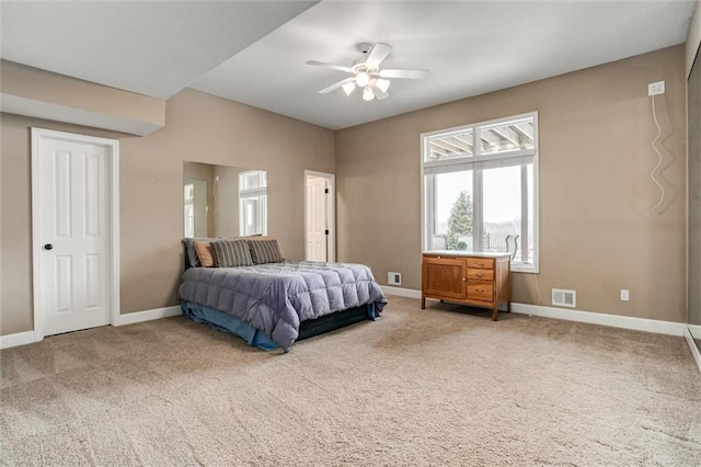 carpeted bedroom featuring baseboards, visible vents, and a ceiling fan