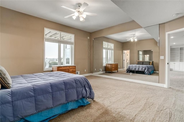 bedroom featuring ceiling fan, multiple windows, carpet, and baseboards