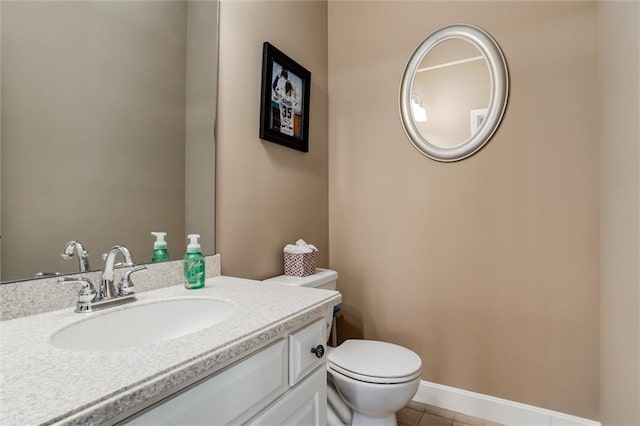 bathroom with toilet, tile patterned flooring, baseboards, and vanity