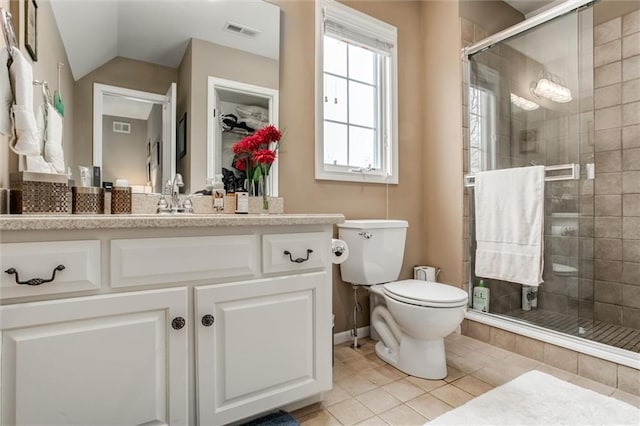 bathroom featuring toilet, vanity, visible vents, vaulted ceiling, and a shower stall