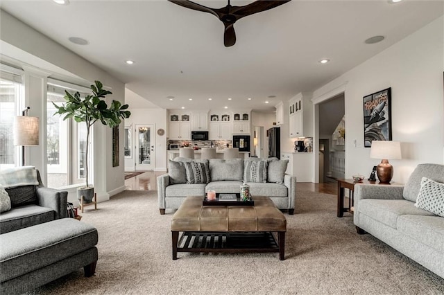 living room featuring light carpet and recessed lighting