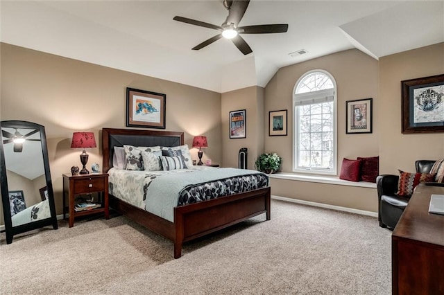 carpeted bedroom featuring lofted ceiling, visible vents, ceiling fan, and baseboards