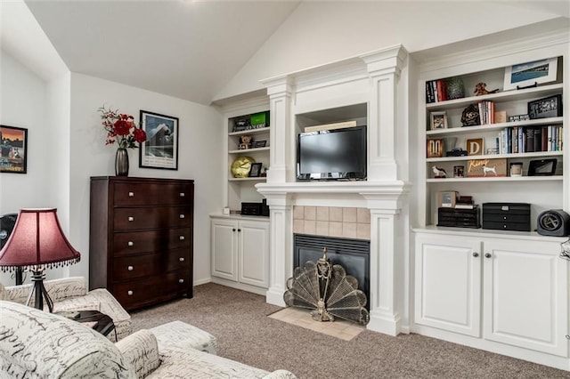 living room featuring a tile fireplace, light colored carpet, and vaulted ceiling