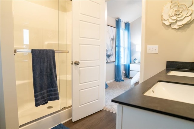 bathroom featuring a shower stall, vanity, and wood finished floors