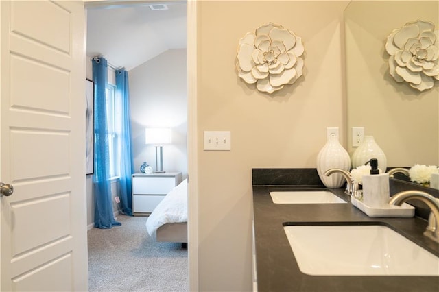 bathroom with lofted ceiling and a sink