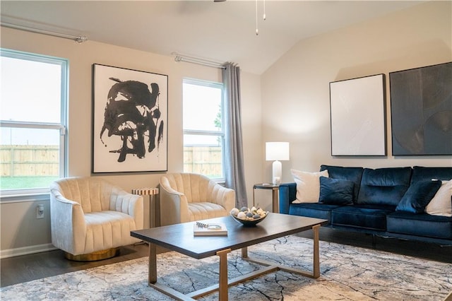 living room with lofted ceiling, a healthy amount of sunlight, baseboards, and wood finished floors