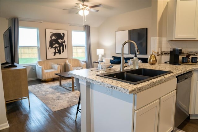 kitchen featuring a wealth of natural light, dark wood-style floors, open floor plan, stainless steel dishwasher, and a sink