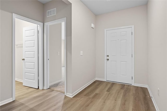 entryway with light wood-style floors, visible vents, and baseboards