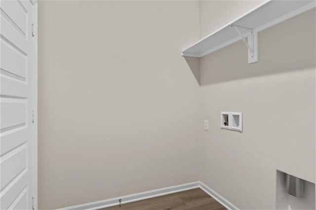 washroom featuring laundry area, hookup for a washing machine, baseboards, and dark wood finished floors