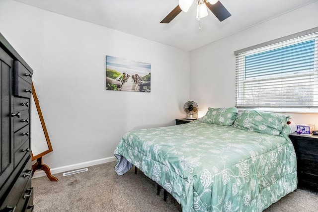 bedroom featuring carpet floors, visible vents, baseboards, and a ceiling fan