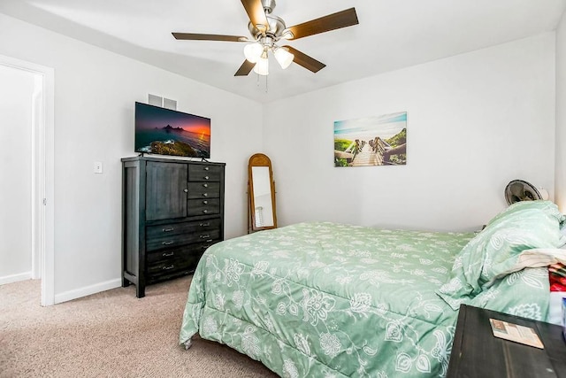 bedroom featuring light carpet, ceiling fan, visible vents, and baseboards