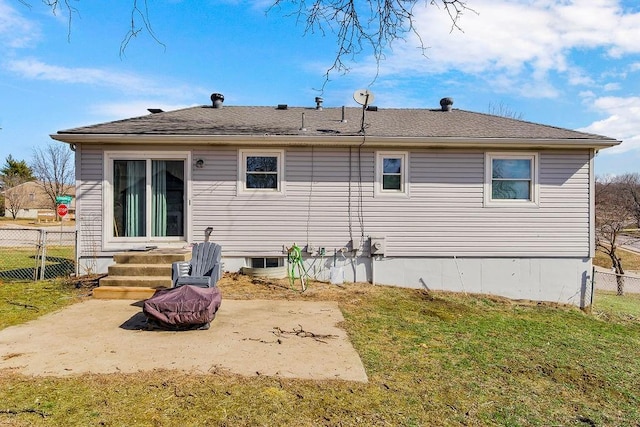 rear view of house with a yard, entry steps, fence, and a patio