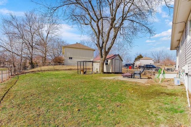 view of yard with a fenced backyard, an outdoor structure, and a storage shed