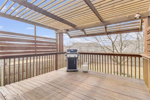 wooden deck featuring a pergola and area for grilling