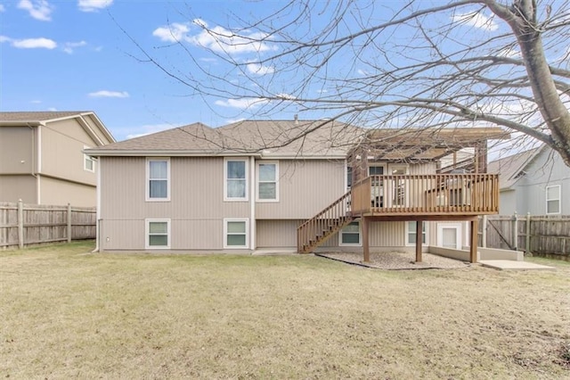 rear view of property featuring a deck, stairway, a fenced backyard, and a lawn