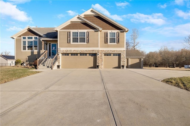 view of front facade featuring a garage, stone siding, and driveway