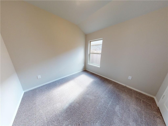 unfurnished room featuring lofted ceiling, carpet floors, and baseboards