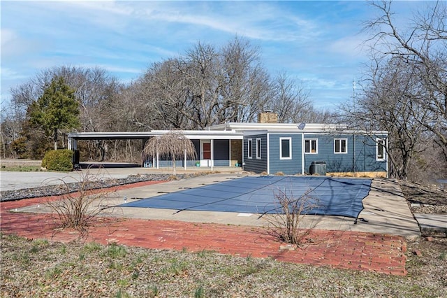 rear view of property with a chimney