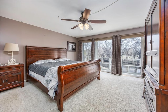 bedroom featuring light carpet, ceiling fan, and access to outside