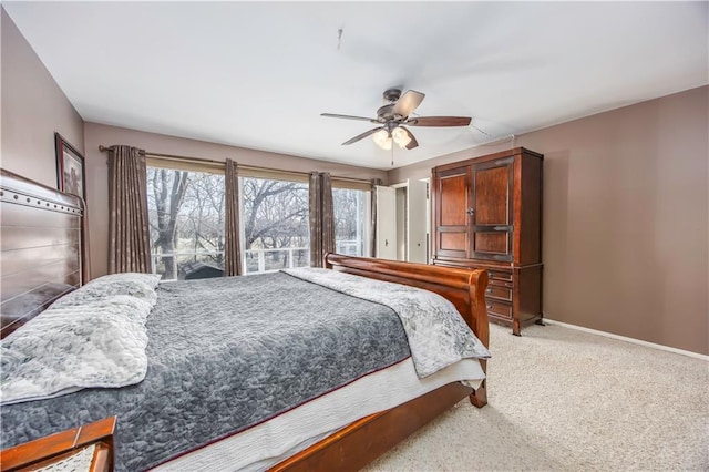 carpeted bedroom with a ceiling fan and baseboards