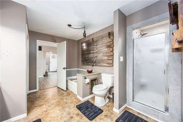 bathroom with baseboards, toilet, a stall shower, and a bath