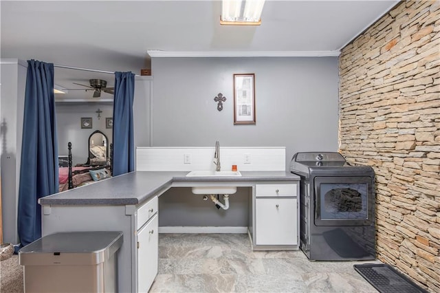 interior space featuring an outdoor kitchen, washer / dryer, and a sink