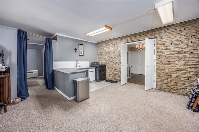 interior space with stove, a wall unit AC, light colored carpet, and ornamental molding