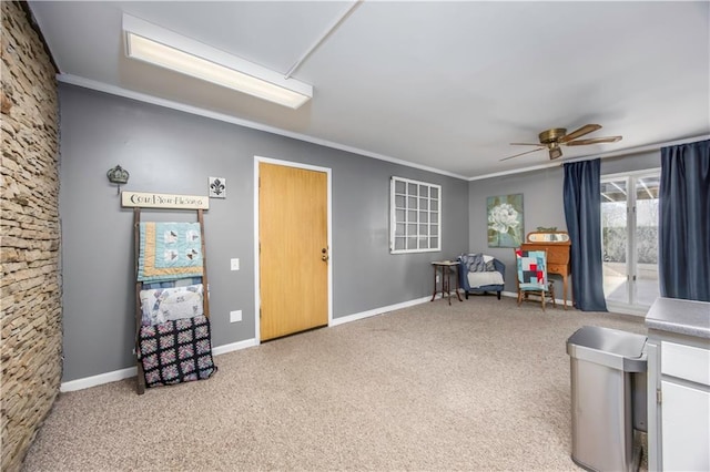 misc room featuring ceiling fan, baseboards, carpet, and ornamental molding