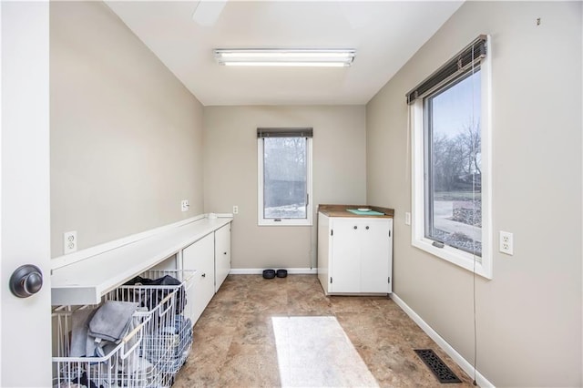 washroom featuring baseboards and visible vents