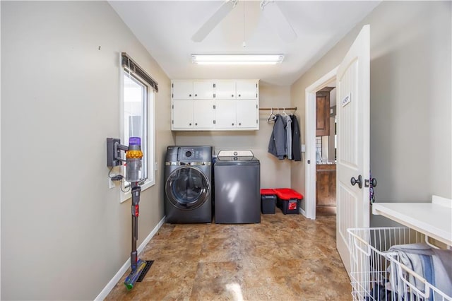 washroom with cabinet space, ceiling fan, baseboards, and separate washer and dryer