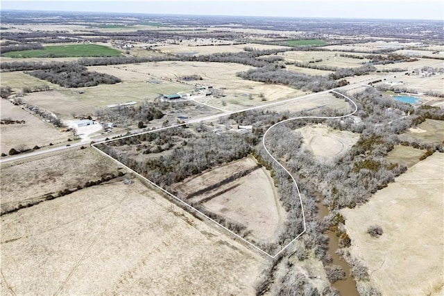 birds eye view of property with a rural view