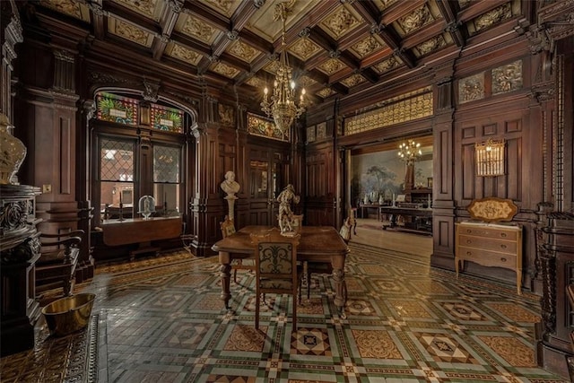 wine cellar featuring ornate columns, a high ceiling, a chandelier, and coffered ceiling