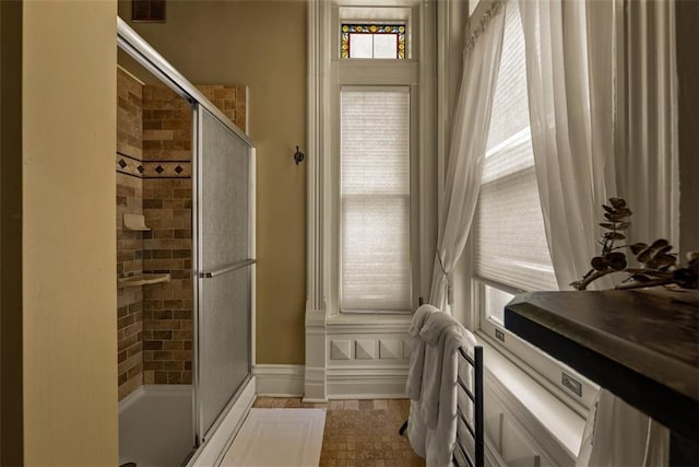 bathroom with a shower stall and visible vents