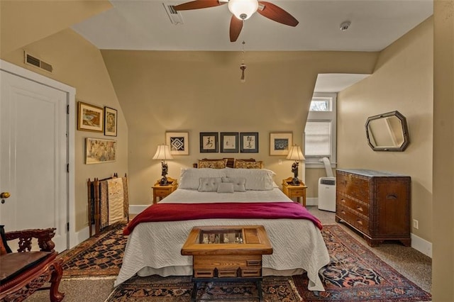 carpeted bedroom featuring a ceiling fan, visible vents, and baseboards