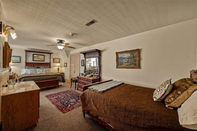 carpeted bedroom with visible vents and ceiling fan