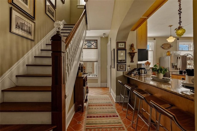 stairs with tile patterned flooring and baseboards