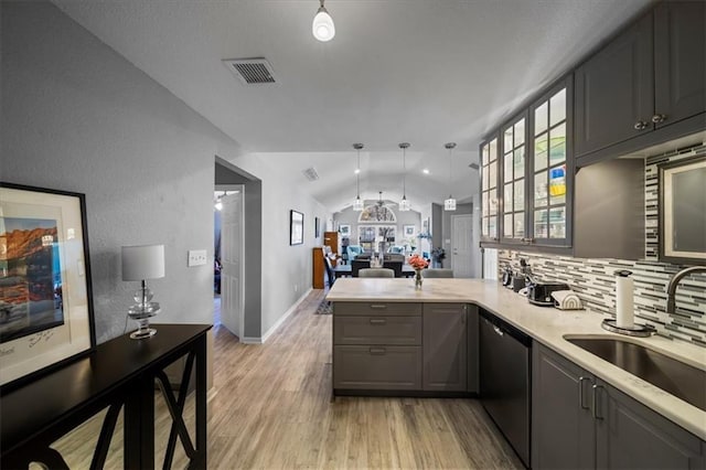 kitchen with lofted ceiling, gray cabinets, visible vents, stainless steel dishwasher, and a peninsula