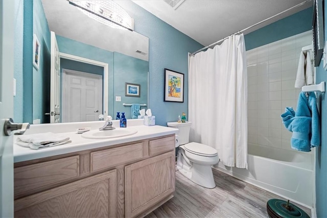 full bath featuring shower / bath combo, vanity, toilet, and wood finished floors