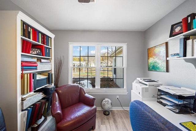 office area with wood finished floors and baseboards