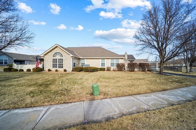 single story home featuring fence and a front lawn