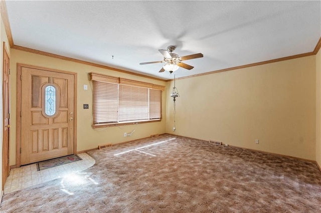 carpeted foyer featuring ceiling fan, ornamental molding, and visible vents