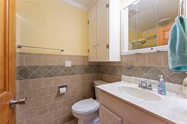 bathroom with toilet, a shower with door, ornamental molding, and vanity