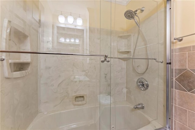 bathroom featuring bath / shower combo with glass door