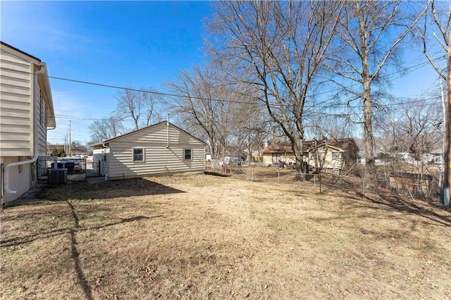 view of yard featuring fence and central AC unit