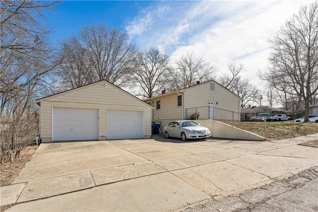 view of side of home with a garage and an outdoor structure