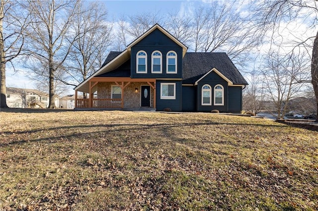 view of front facade featuring covered porch and a front lawn